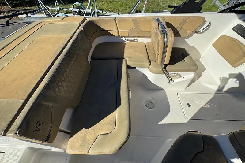Slide: The Image of 2022 Bayliner VR6 Bowrider OB interior with tan seating and spacious layout. - 18