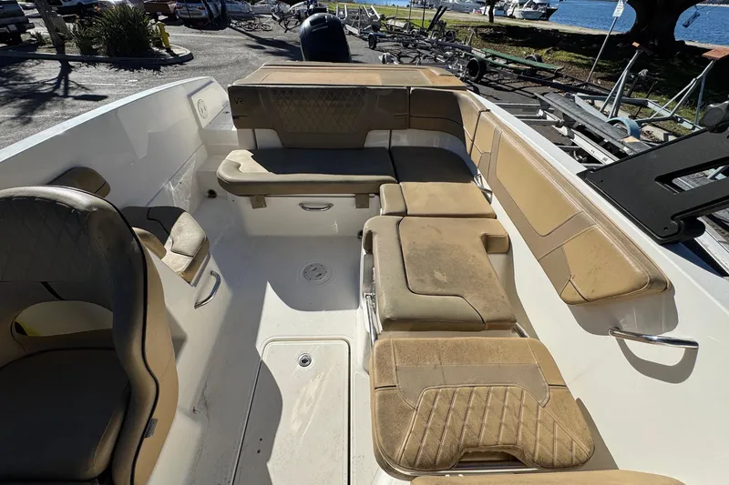 Slide: The Image of 2022 Bayliner VR6 Bowrider OB interior with tan seating and spacious layout. - 20