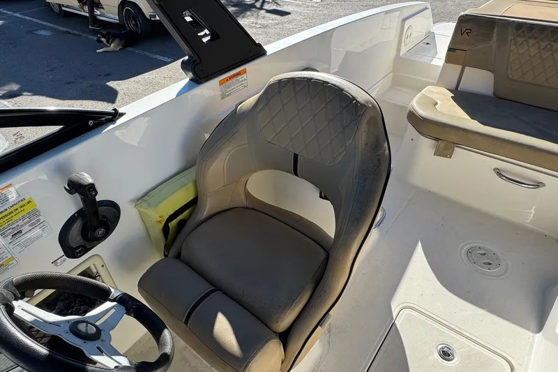 Slide: The Image of 2022 Bayliner VR6 Bowrider OB interior with steering wheel and seating. - 26