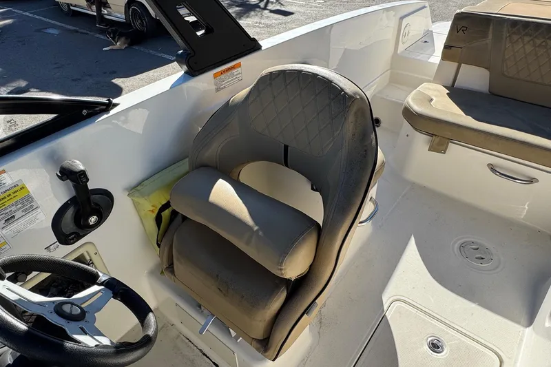 Slide: The Image of 2022 Bayliner VR6 Bowrider OB interior with steering wheel and cushioned seating. - 27