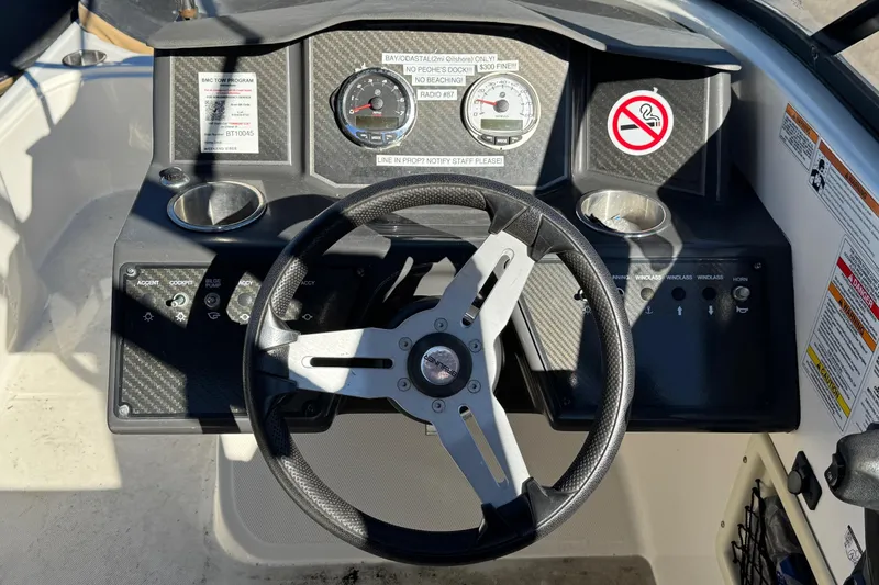 Slide: The Image of 2022 Bayliner VR6 Bowrider OB dashboard with steering wheel and control panel. - 28