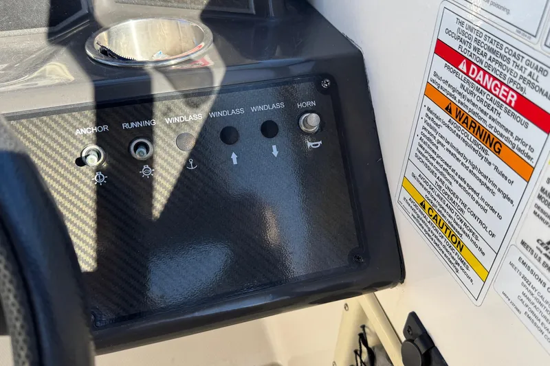 Slide: The Image of Control panel of 2022 Bayliner VR6 Bowrider OB with warning labels and switches. - 30