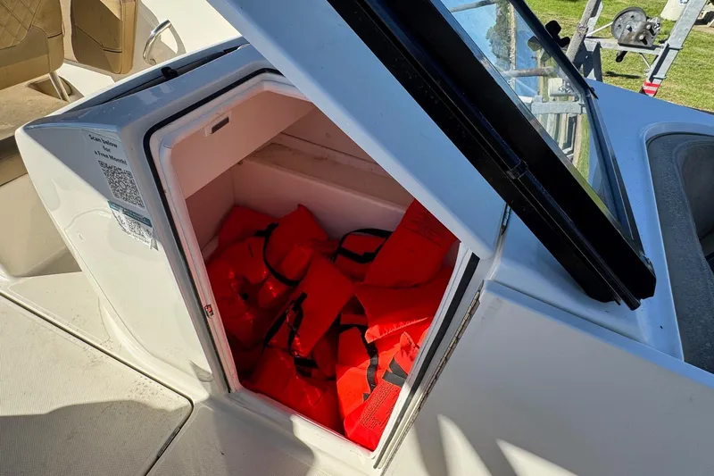 Slide: The Image of 2022 Bayliner VR6 Bowrider OB storage compartment with life jackets inside. - 34
