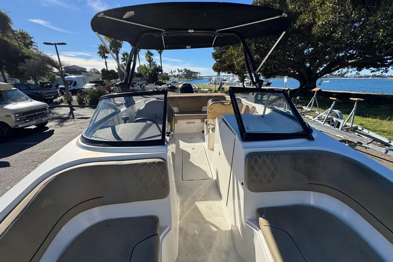 Slide: The Image of 2022 Bayliner VR6 Bowrider OB with spacious seating, docked near a scenic waterfront. - 39