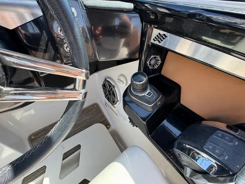 Slide: The Image of 2018 Four Winns H290 OB boat dashboard with steering wheel and control panel. - 17