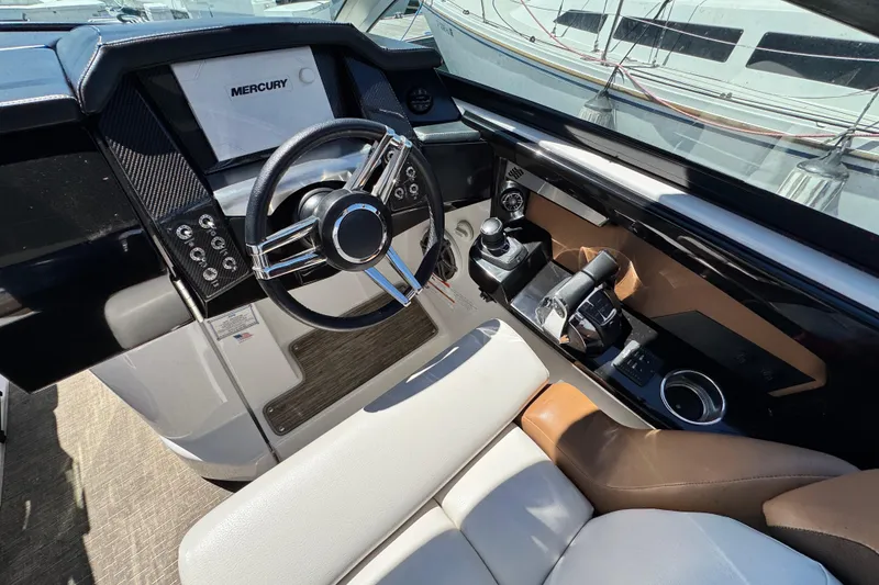 Slide: The Image of 2018 Four Winns H290 OB boat cockpit with Mercury controls and luxurious seating. - 22