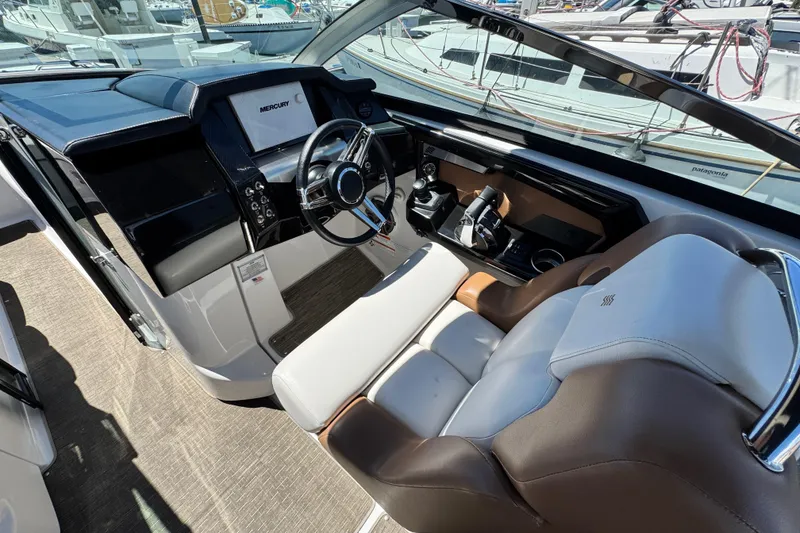 Slide: The Image of 2018 Four Winns H290 OB boat cockpit with steering wheel and control panel. - 32