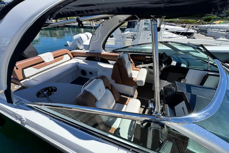 Slide: The Image of 2018 Four Winns H290 OB boat interior with luxurious seating and modern dashboard. - 34