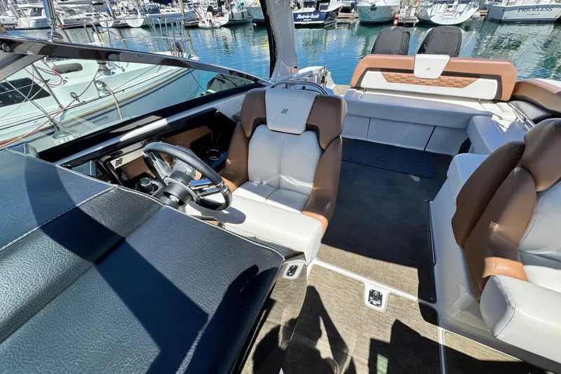 Slide: The Image of Interior of 2018 Four Winns H290 OB boat with luxurious seating and steering wheel. - 36