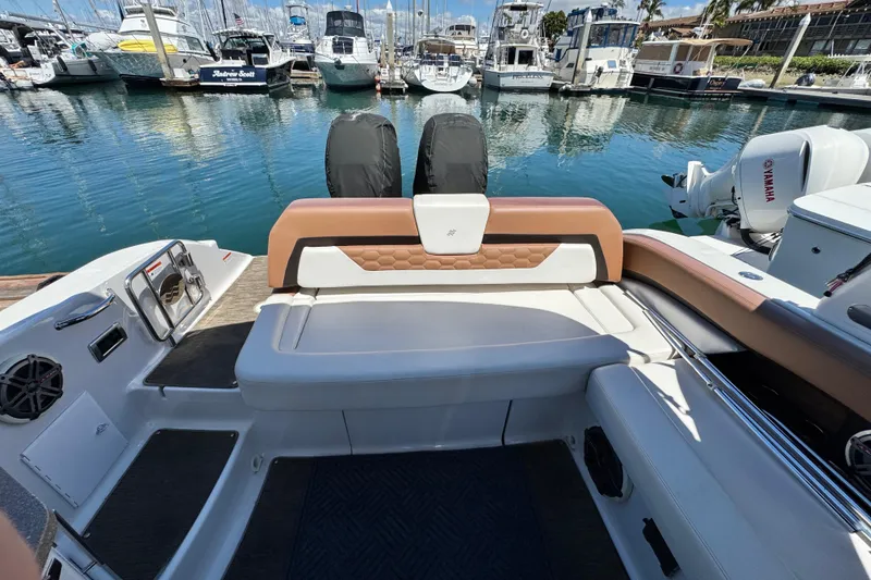 Slide: The Image of 2018 Four Winns H290 OB boat interior with seating, docked at marina. - 38
