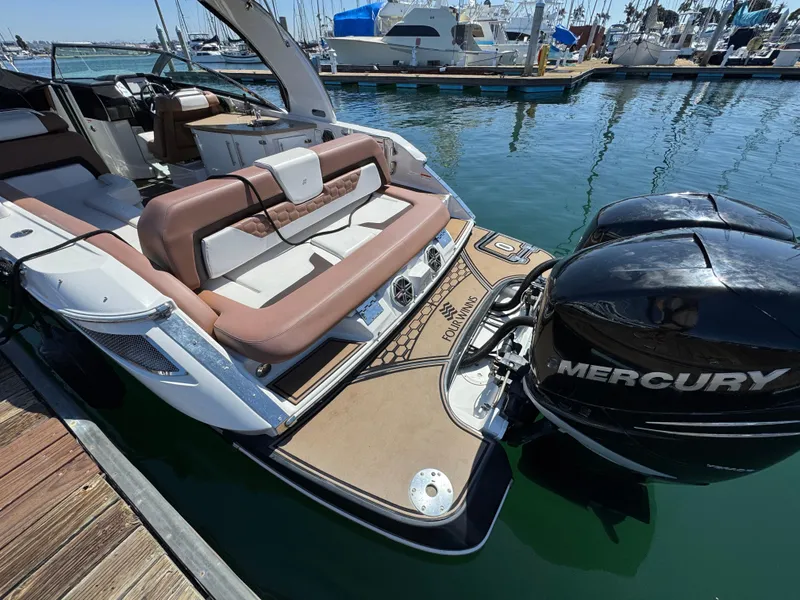 Slide: The Image of 2018 Four Winns H290 OB boat with Mercury outboard engine docked at marina. - 6