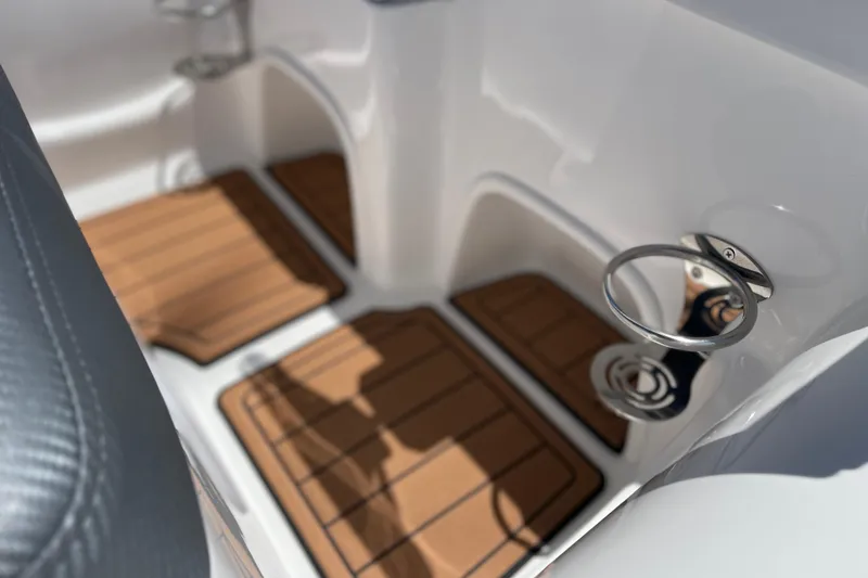 Slide: The Image of Interior of 2025 Caribe DL11 boat with wooden flooring and cup holders. - 18