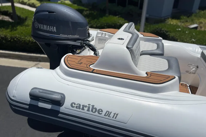Slide: The Image of Caribe DL11 boat with Yamaha engine, featuring sleek seating and modern design, 2025 model. - 21