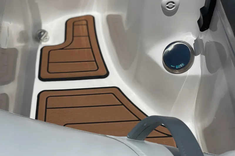 Slide: The Image of Interior of 2025 Caribe DL11 boat with wooden floor mats and water cap. - 26