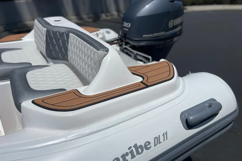 Slide: The Image of Caribe DL11 boat, 2025 model, featuring stylish seating and Yamaha outboard motor. - 28