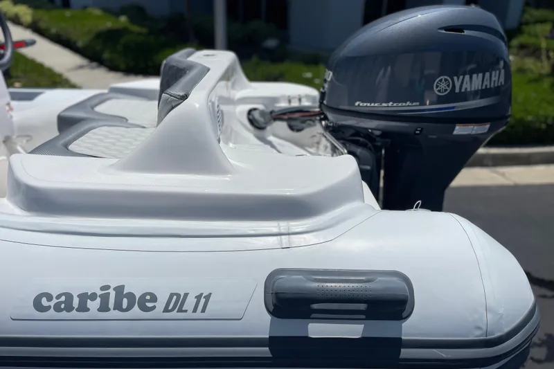 Slide: The Image of 2025 Caribe DL11 inflatable boat with Yamaha four-stroke outboard motor. - 3
