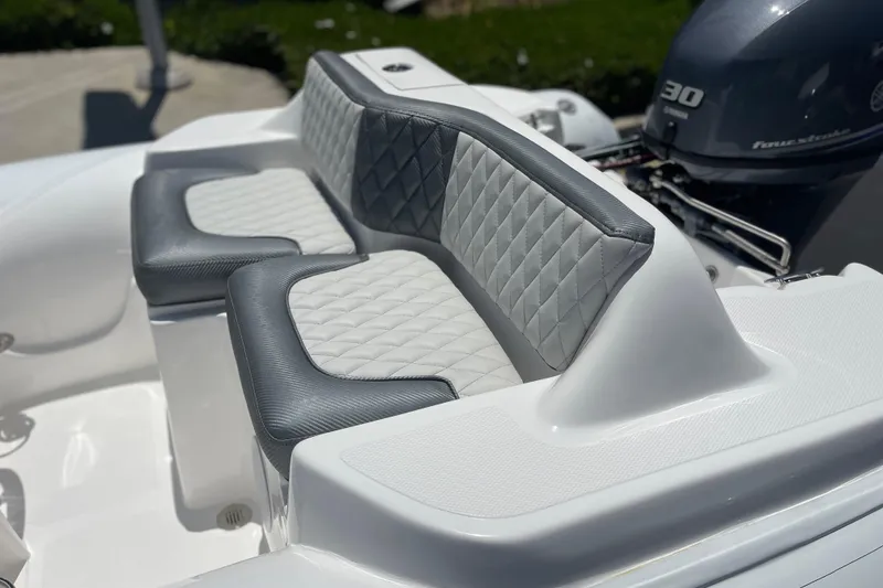 Slide: The Image of 2025 Caribe DL11 boat with quilted gray and white seating, featuring a 30 horsepower engine. - 4