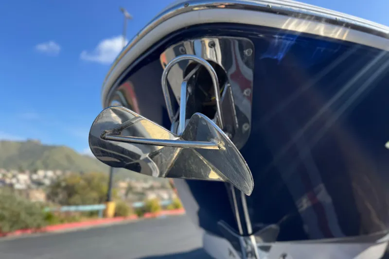 Slide: The Image of 2017 Chaparral 2870 SSX boat anchor detail with blue hull and scenic background. - 12