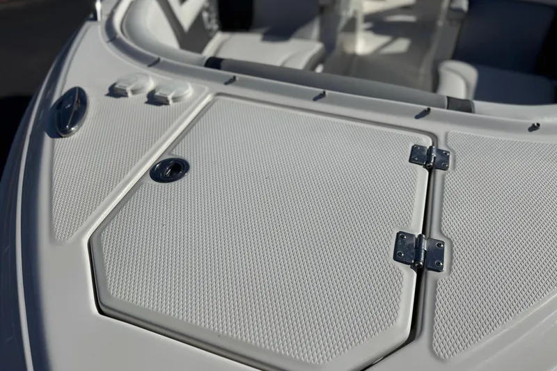 Slide: The Image of 2017 Chaparral 2870 SSX boat deck with textured surface and metal hinges. - 13