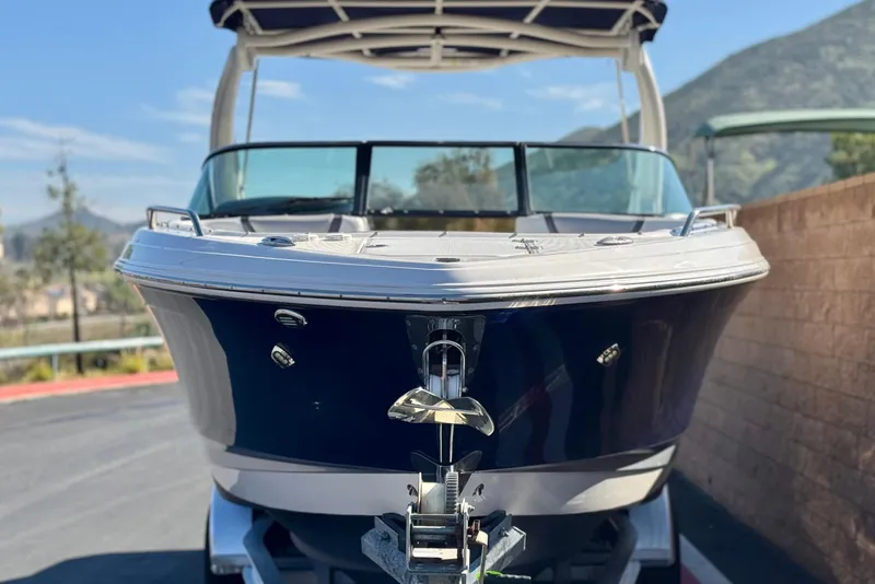 Slide: The Image of 2017 Chaparral 2870 SSX boat on trailer, front view with mountainous background. - 2