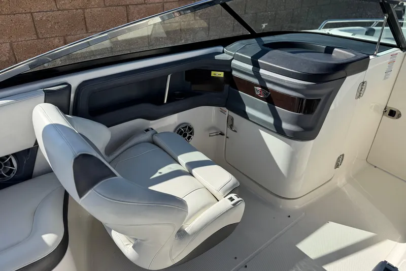 Slide: The Image of 2017 Chaparral 2870 SSX boat interior with white seating and dashboard. - 30