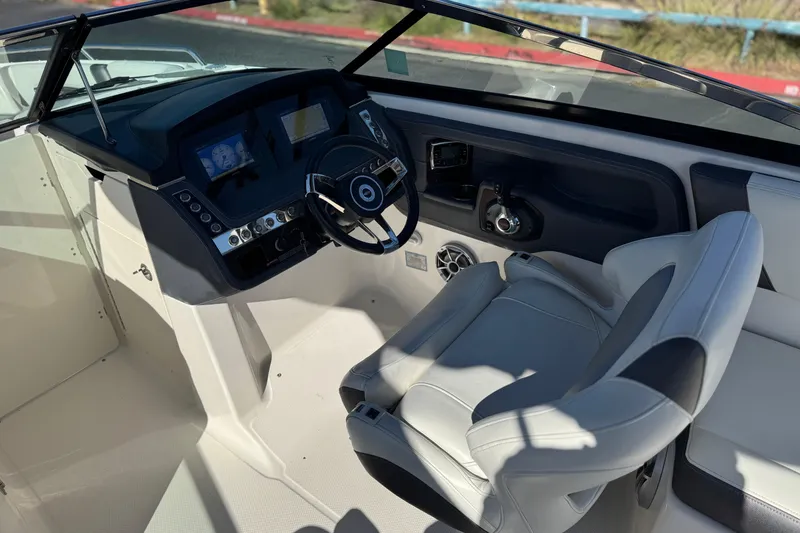 Slide: The Image of 2017 Chaparral 2870 SSX boat cockpit with steering wheel and control panel. - 33