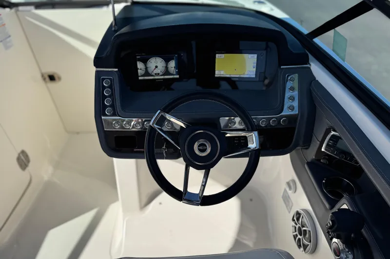 Slide: The Image of 2017 Chaparral 2870 SSX boat dashboard with steering wheel and control panel. - 34