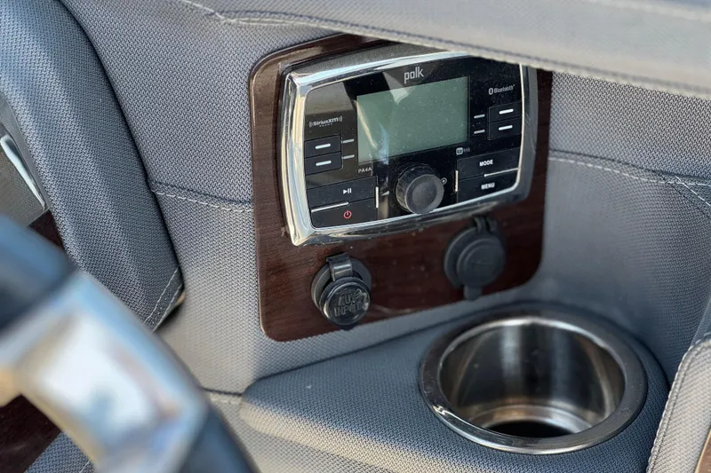 Slide: The Image of 2017 Chaparral 2870 SSX boat dashboard with Polk audio system and cup holder. - 36