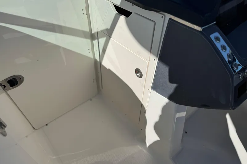 Slide: The Image of 2017 Chaparral 2870 SSX boat interior, featuring a sleek control panel and storage compartment. - 37