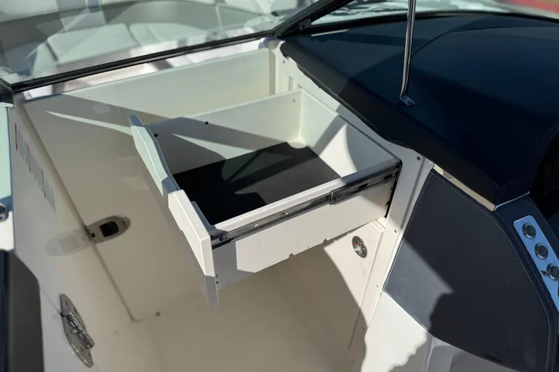 Slide: The Image of 2017 Chaparral 2870 SSX boat interior with open storage compartment. - 38