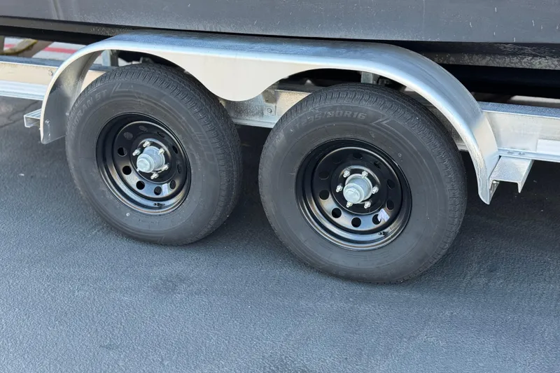Slide: The Image of Trailer wheels of a 2017 Chaparral 2870 SSX boat on asphalt surface. - 40