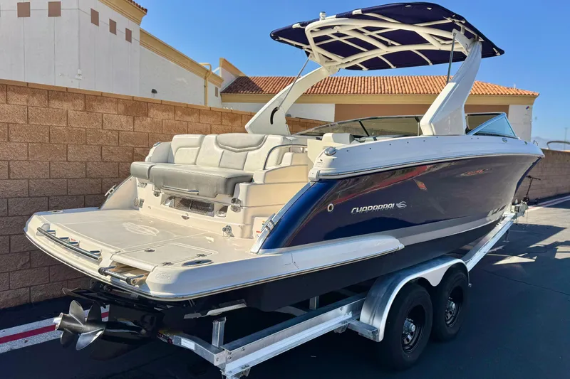 Slide: The Image of 2017 Chaparral 2870 SSX boat on trailer, parked outdoors, showcasing sleek design. - 5