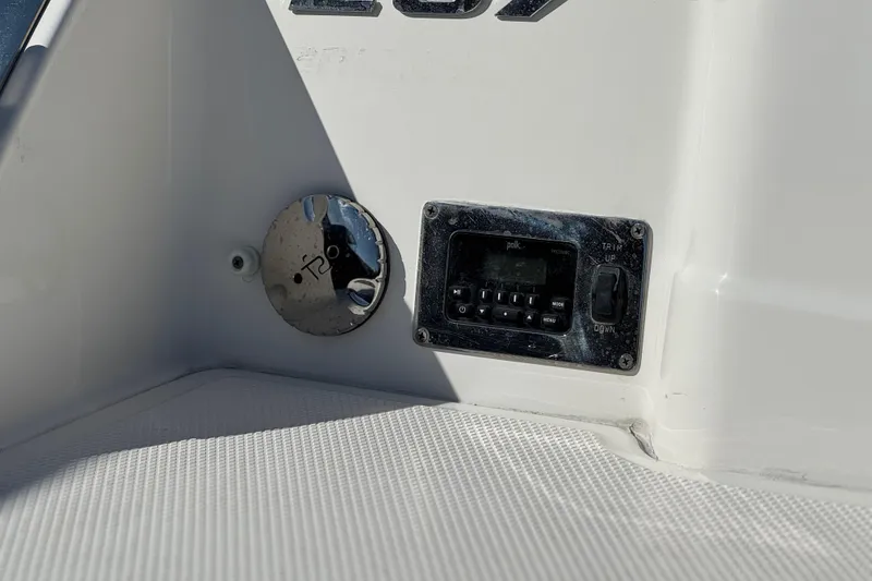 Slide: The Image of Control panel on 2017 Chaparral 2870 SSX boat, featuring audio system and trim controls. - 7
