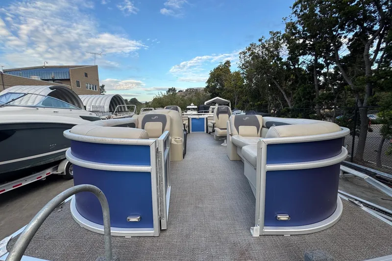 Slide: The Image of 2023 Barletta ARIA 22QC pontoon boat with blue exterior and spacious seating. - 20
