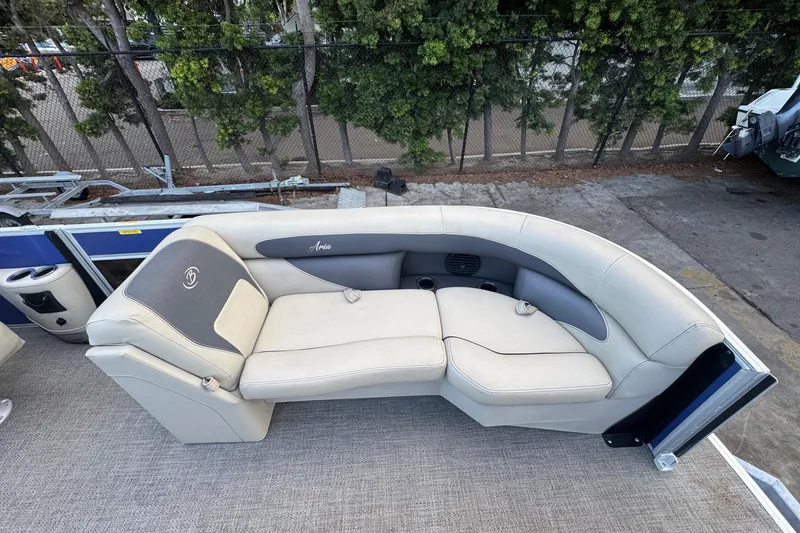 Slide: The Image of 2023 Barletta ARIA 22QC boat seating with beige upholstery and cup holders. - 22