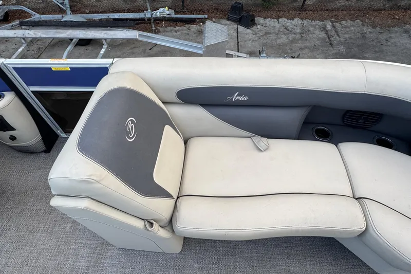 Slide: The Image of 2023 Barletta ARIA 22QC boat seating with gray and cream upholstery, featuring cup holders. - 26