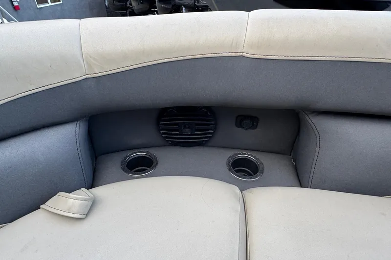 Slide: The Image of 2023 Barletta ARIA 22QC boat interior with cup holders and speaker. - 33