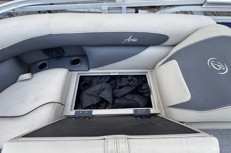 Slide: The Image of 2023 Barletta ARIA 22QC boat seat storage compartment with open lid. - 56