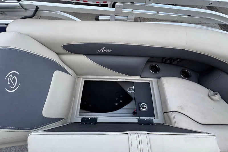 Slide: The Image of 2023 Barletta ARIA 22QC boat interior with storage compartment and cup holders. - 64