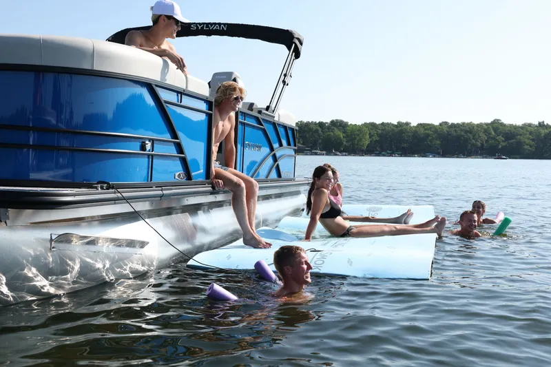 Slide: The Image of People relaxing on a Sylvan Mirage X3 DH pontoon boat, 2026 model. - 2