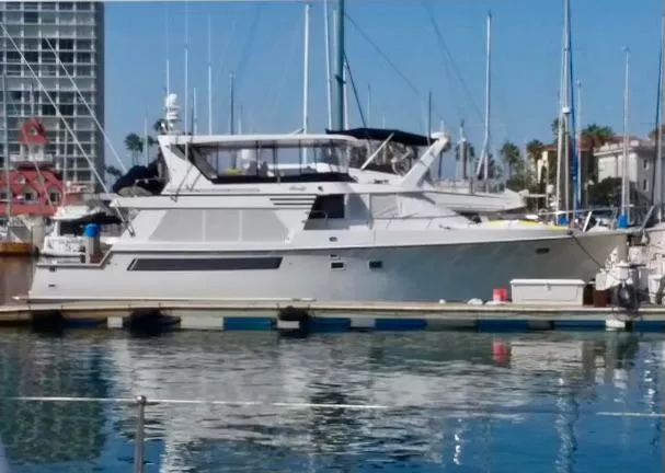 Slide: The Image of 1993 Tollycraft 57 Pilothouse yacht docked in marina. - 1
