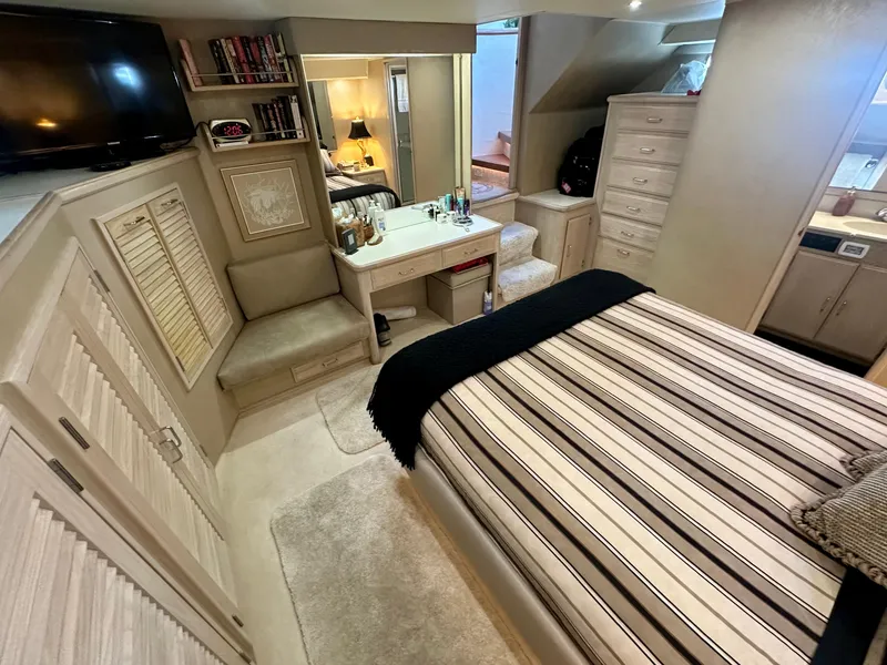 Slide: The Image of Interior of 1993 Tollycraft 57 Pilothouse yacht, bedroom with striped bedding. - 14
