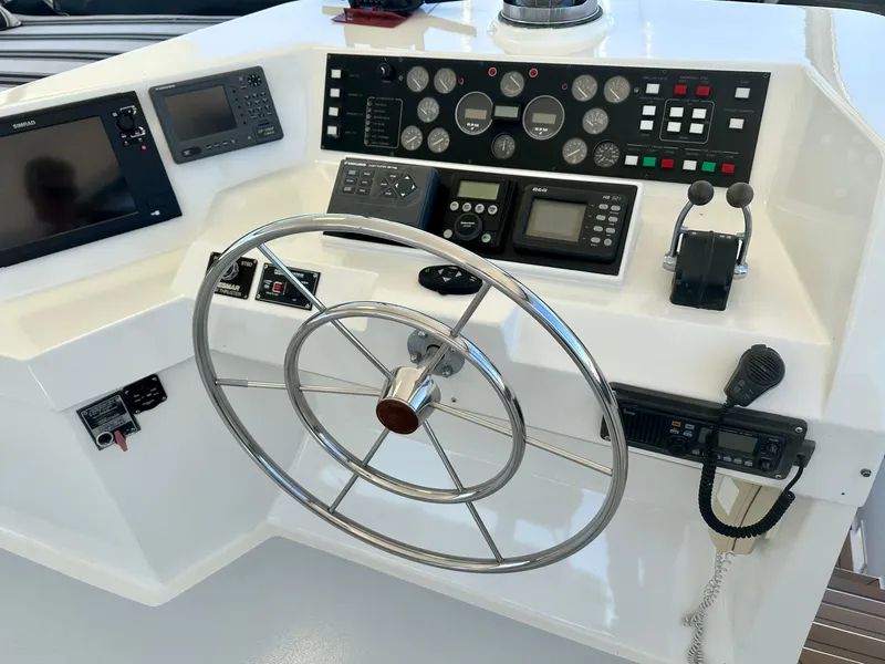 Slide: The Image of 1993 Tollycraft 57 Pilothouse helm with steering wheel and controls. - 23