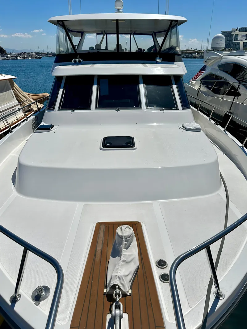 Slide: The Image of 1993 Tollycraft 57 Pilothouse yacht docked, front view. - 29
