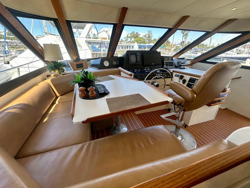 Slide: The Image of Interior of 1993 Tollycraft 57 Pilothouse yacht with leather seating and helm station. - 11