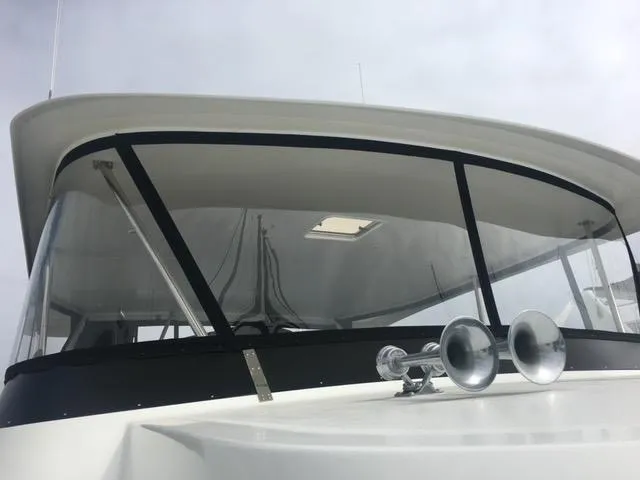 Slide: The Image of 1993 Tollycraft 57 Pilothouse yacht docked, modern design. - 27