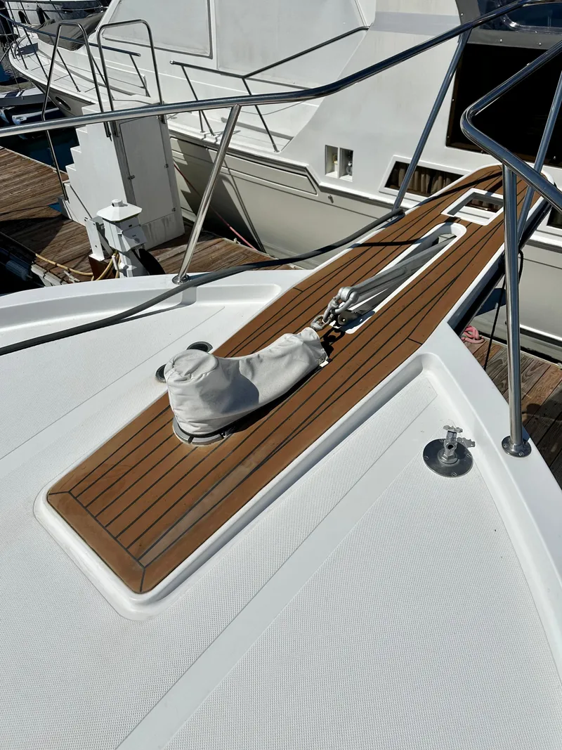Slide: The Image of 1993 Tollycraft 57 Pilothouse foredeck with wood trim and stainless steel railing. - 31