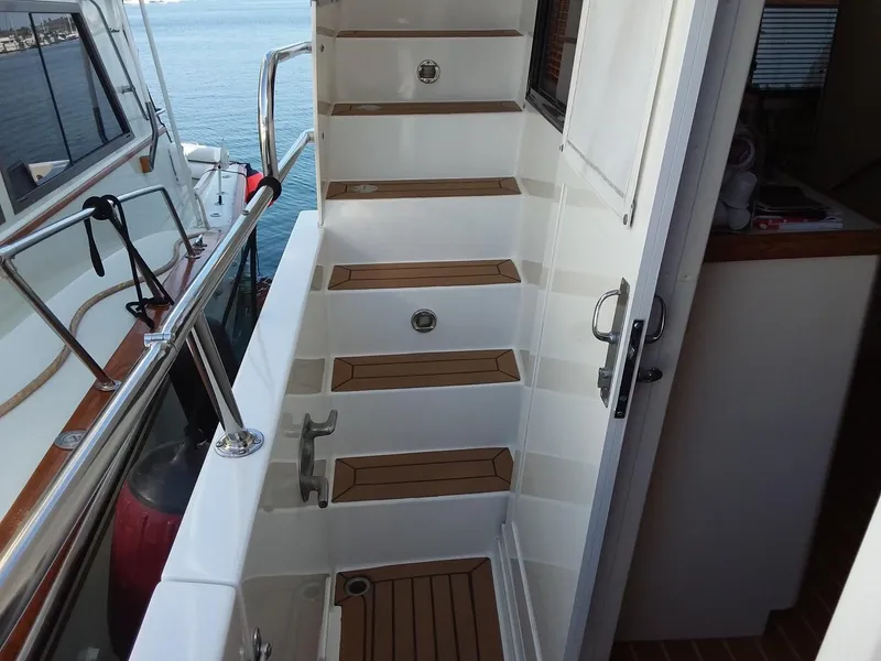 Slide: The Image of Tollycraft 57 Pilothouse 1993 staircase with wooden steps. - 33