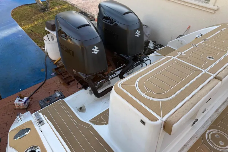 Slide: The Image of 2000 Century 3100 Walk-Around boat with dual Suzuki outboard motors. - 19