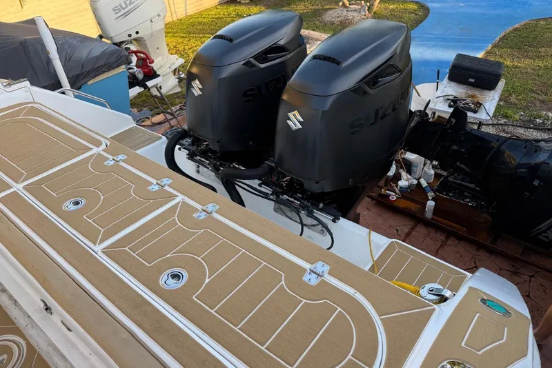 Slide: The Image of 2000 Century 3100 Walk-Around boat with dual Suzuki outboard engines, featuring a tan deck. - 20